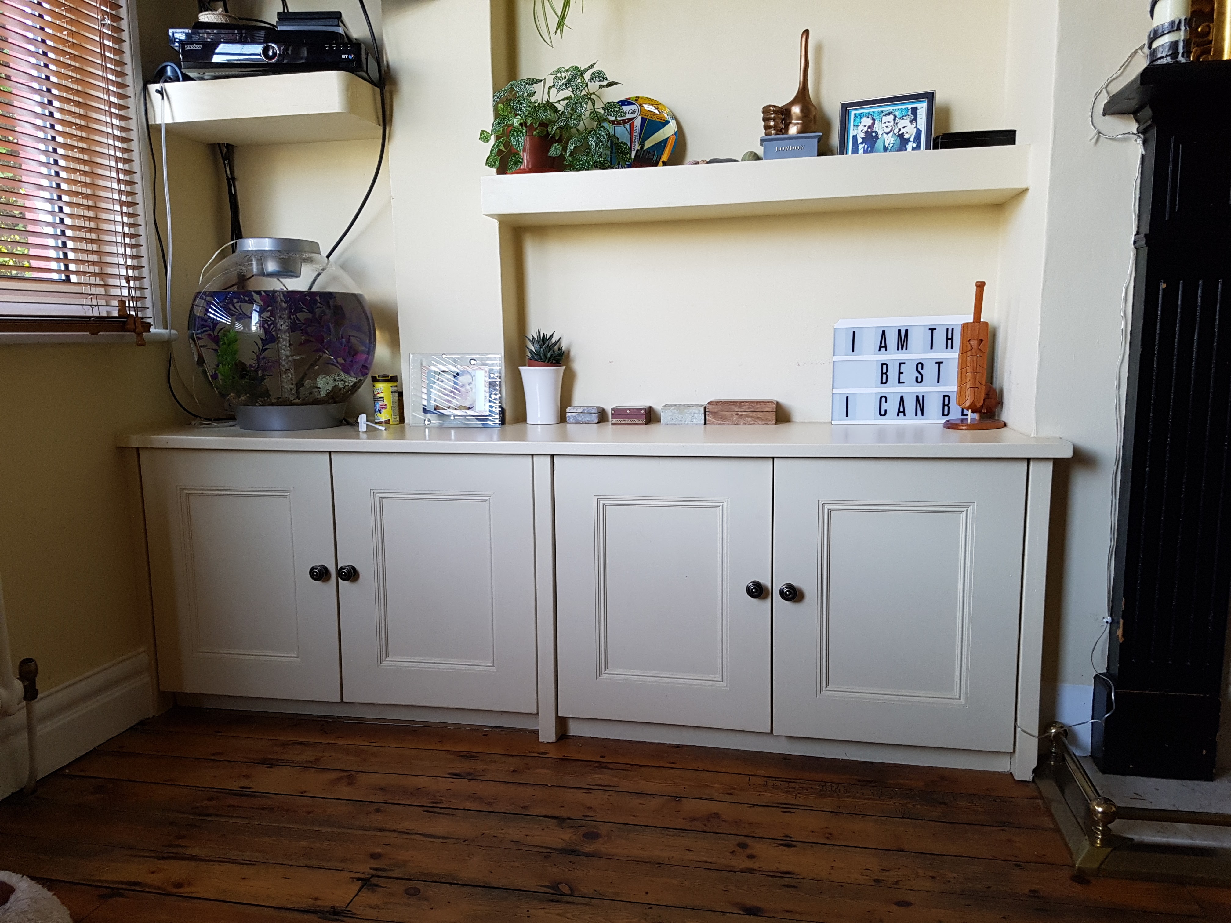 Traditional Slaked Lime alcove unit with cupboards and shelving in a living room